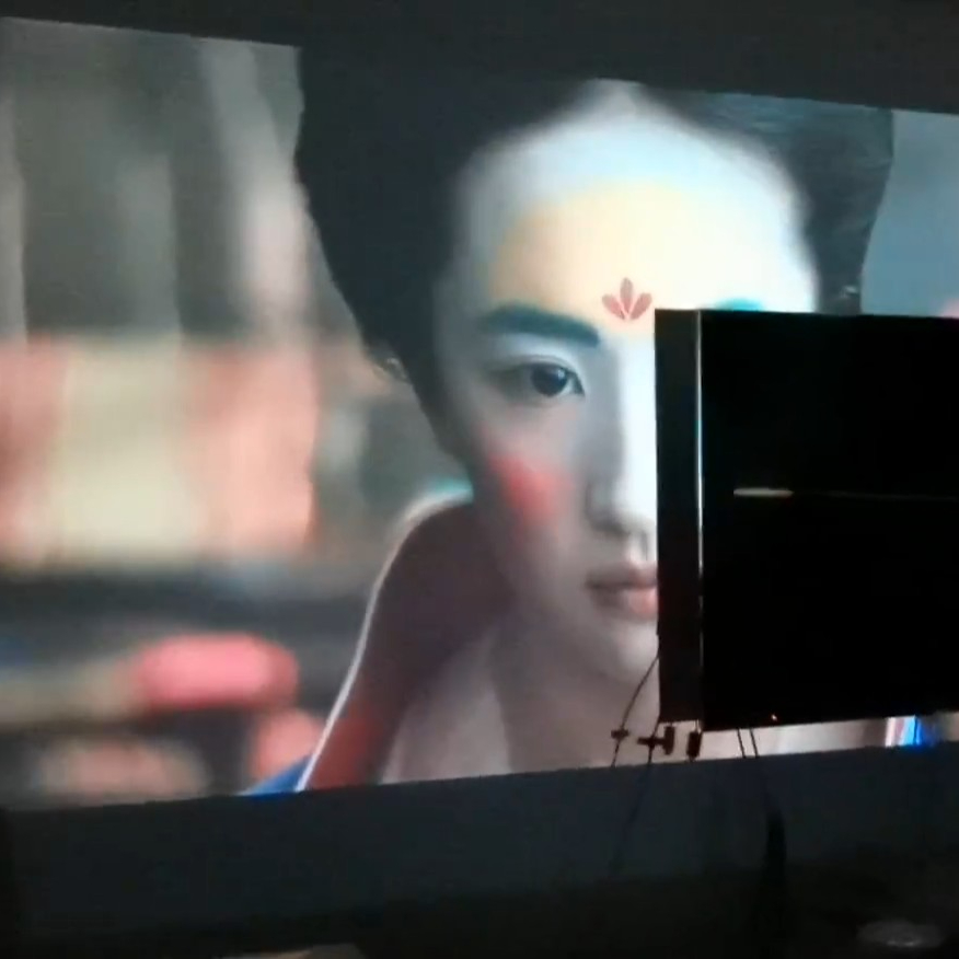 Projected image of 130 inches from Wanbo T2 Max compared to 46-inch television, illustrating significant size difference and viewing experience