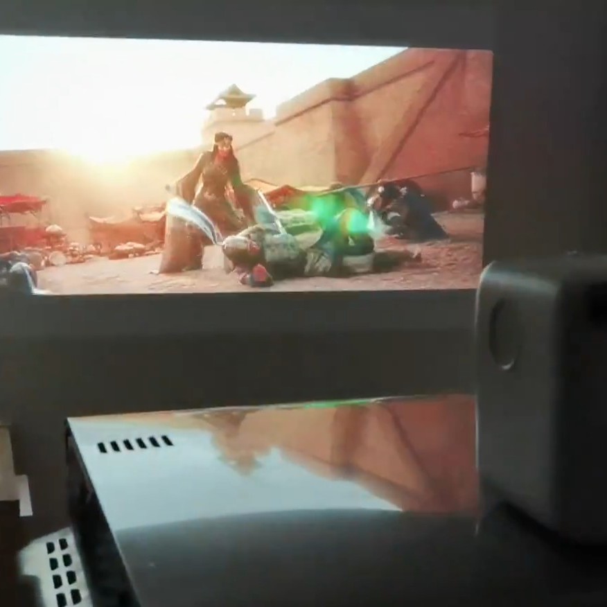 Wanbo T2 Max projector in action, vividly projecting the trailer of Disney's Mulan movie